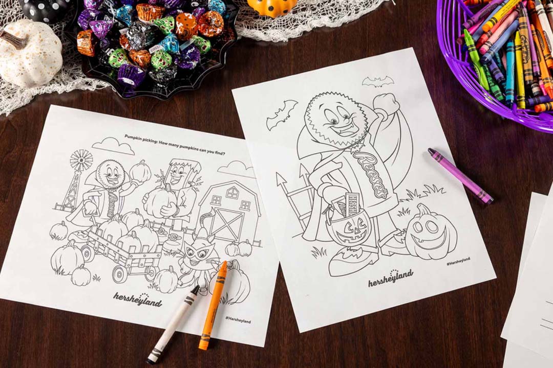 hershey halloween mascot coloring pages and crayons scattered across tabletop